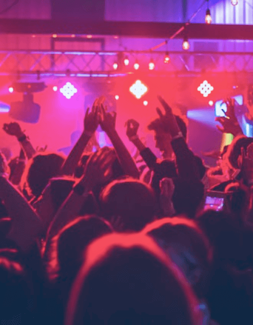 a person on a stage with a crowd watching