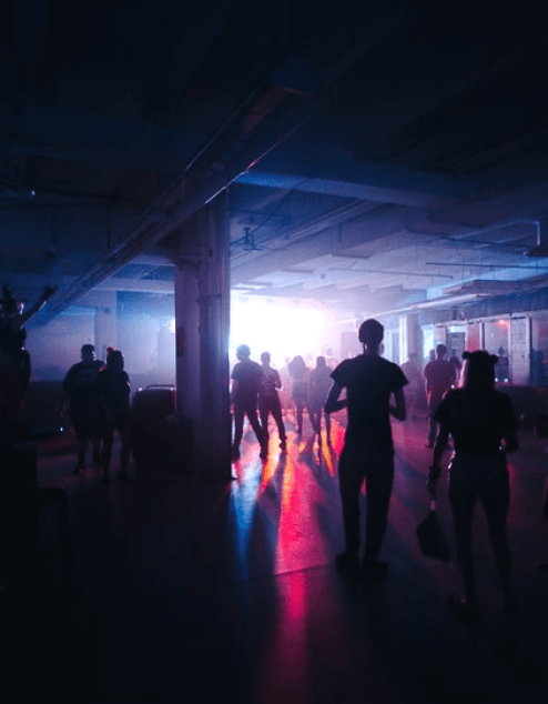 a group of people walking in a club